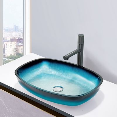 ガラス勾配の青はメロンが取付けられるテーブルの上のカウンタートップを形づけるBathの洗面器を和らげた